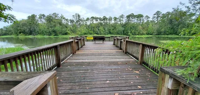 a balcony with wooden floor and lake view