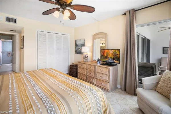 a bedroom with a balcony a bed and a chandelier