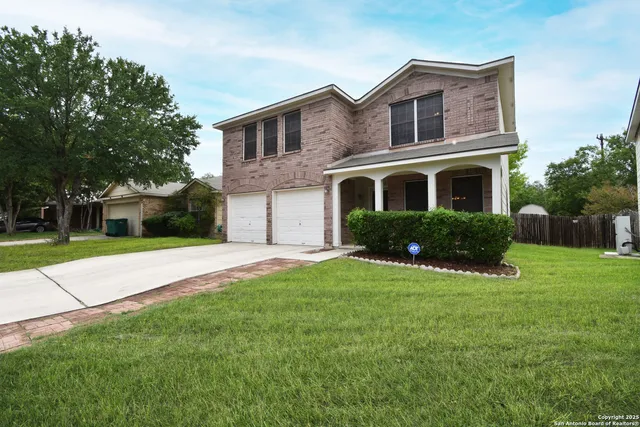 a front view of house with yard and green space