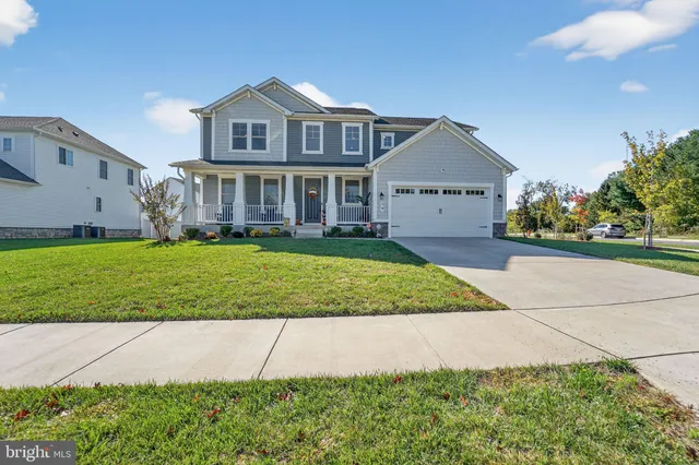 a view of a big house with a big yard and potted plants
