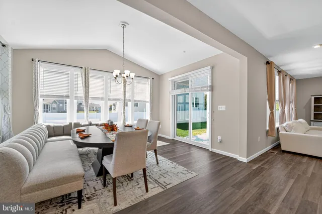 a dining room with furniture wooden floor and a rug
