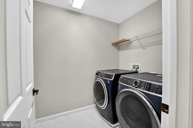 a view of storage and utility room with washer and dryer