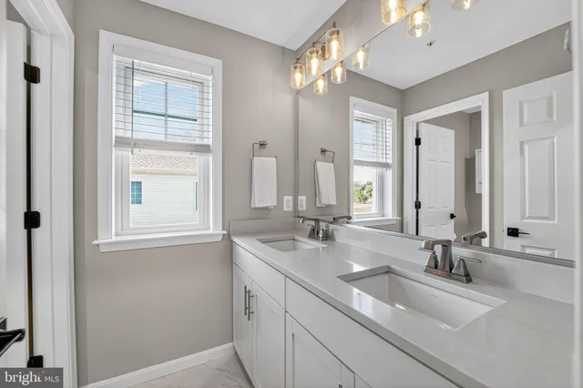 a bedroom with a bed and a flat tv screen on dresser
