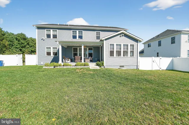 a front view of a house with a yard table and chairs