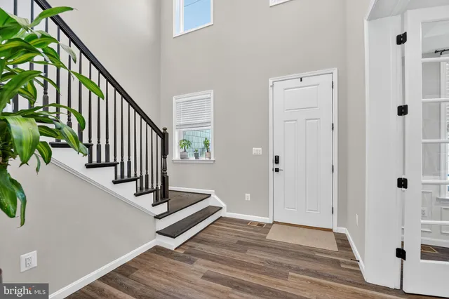 a view of entryway with wooden floor and stairs