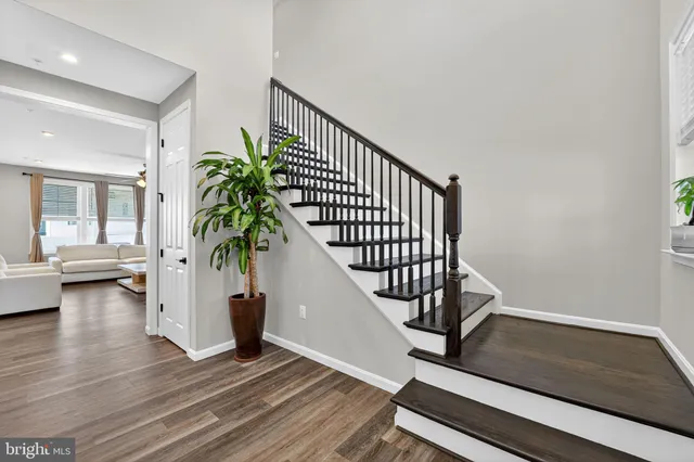 a view of entryway with wooden floor and stairs