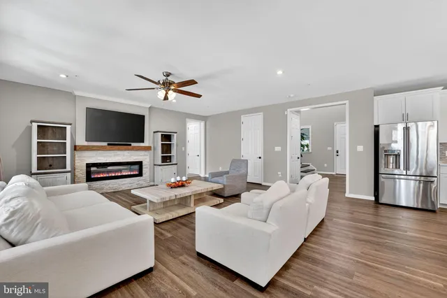 a living room with furniture fireplace and flat screen tv