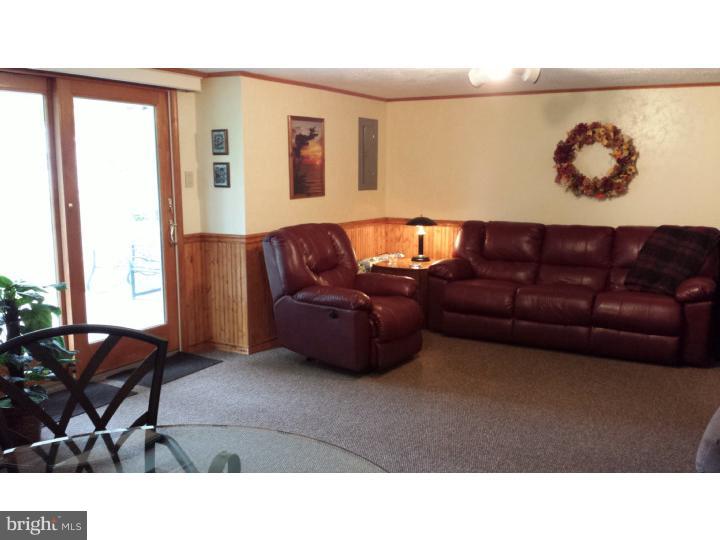 1156 Norwalk Road Philadelphia, PA 19115 - Photo 14 of 23 a living room with furniture and a large window