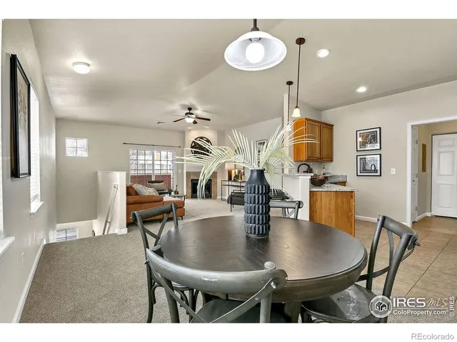 a dining room with wooden floor a glass table and chairs