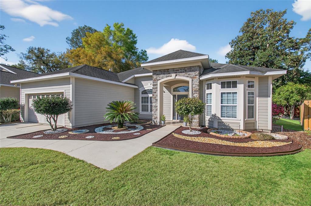 3762 Southwest 74th Drive Gainesville, FL 32608 - Photo 1 of 37 a front view of a house with a yard