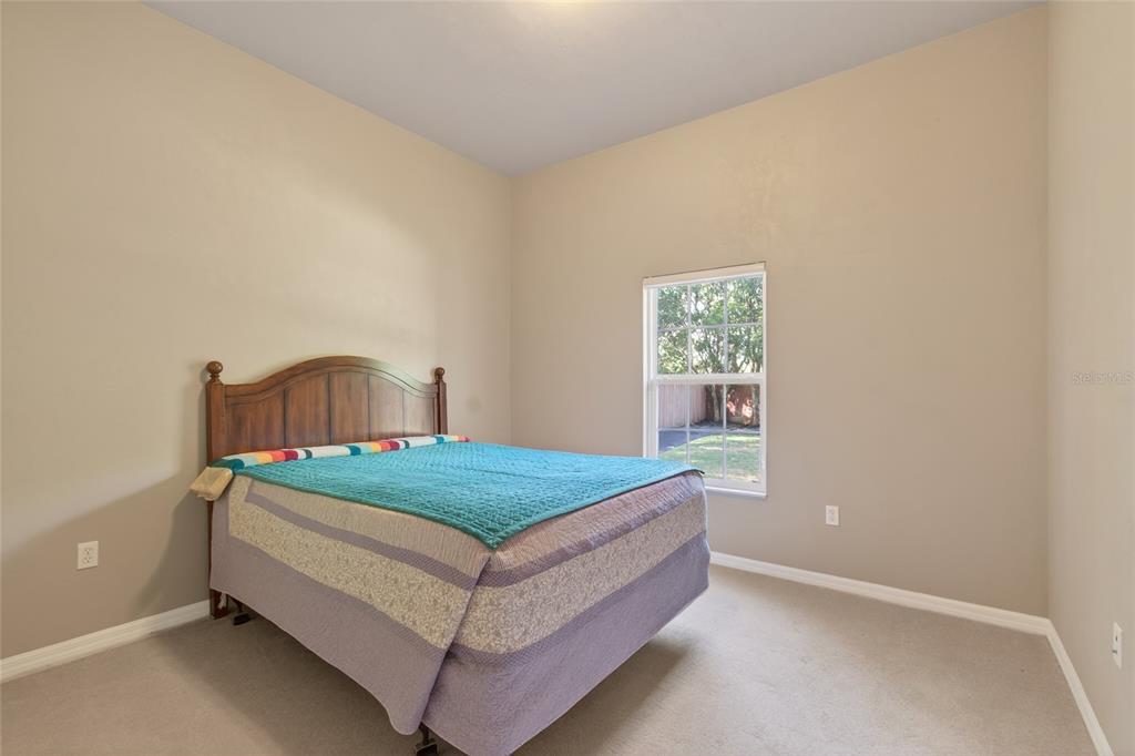 3762 Southwest 74th Drive Gainesville, FL 32608 - Photo 11 of 37 a bedroom with a bed and window