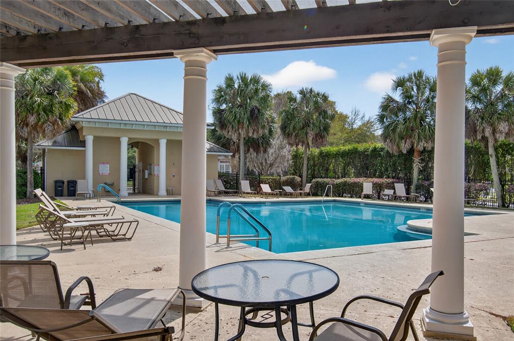 3762 Southwest 74th Drive Gainesville, FL 32608 - Photo 15 of 37 a view of a patio with table and chairs potted plants with wooden floor and fence