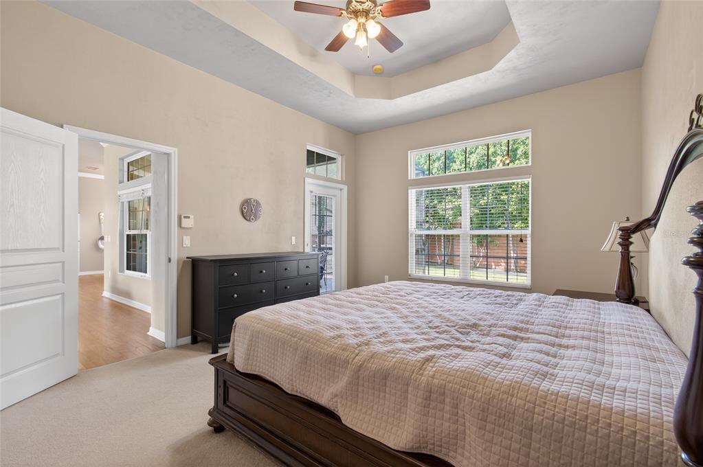 3762 Southwest 74th Drive Gainesville, FL 32608 - Photo 18 of 37 a bedroom with a bed and a chandelier
