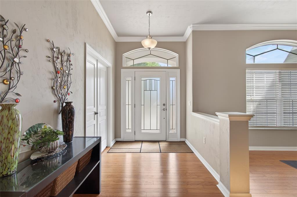 3762 Southwest 74th Drive Gainesville, FL 32608 - Photo 2 of 37 a view of a hallway with wooden floor and staircase