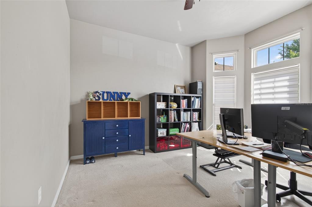 3762 Southwest 74th Drive Gainesville, FL 32608 - Photo 21 of 37 a view of a workspace with furniture and a window