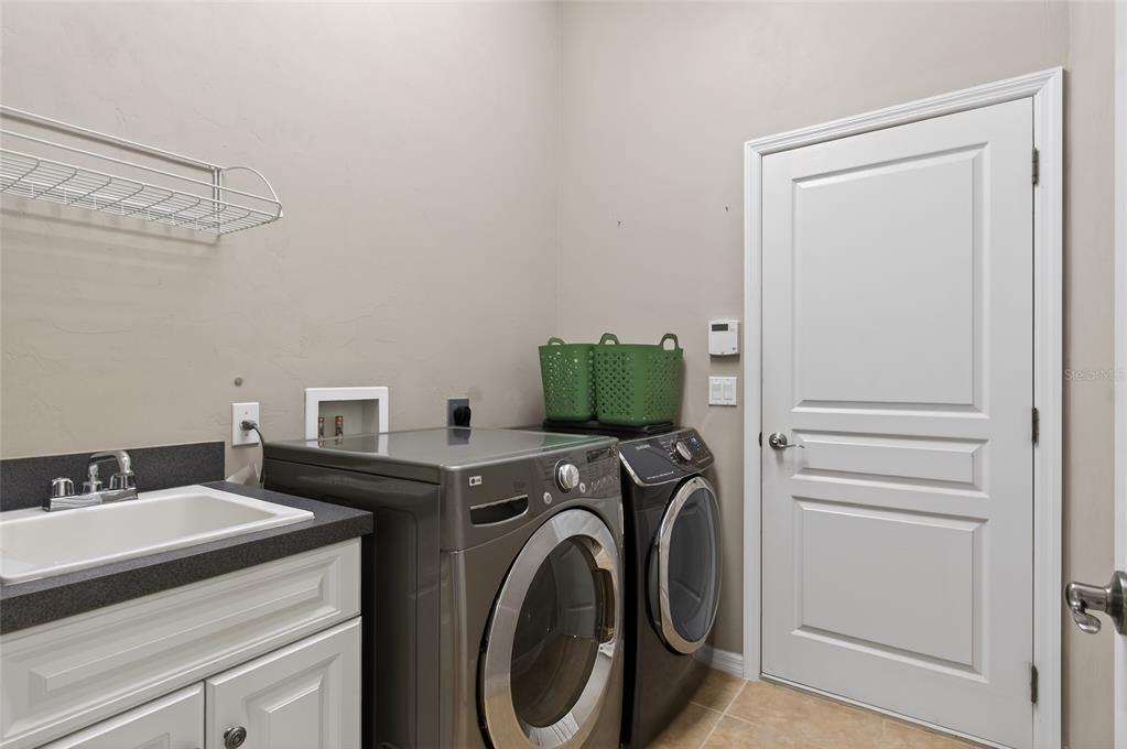 3762 Southwest 74th Drive Gainesville, FL 32608 - Photo 25 of 37 a utility room with dryer and washer