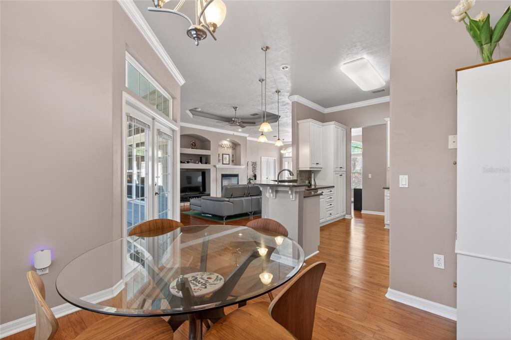 3762 Southwest 74th Drive Gainesville, FL 32608 - Photo 26 of 37 a living room with furniture kitchen view and a chandelier