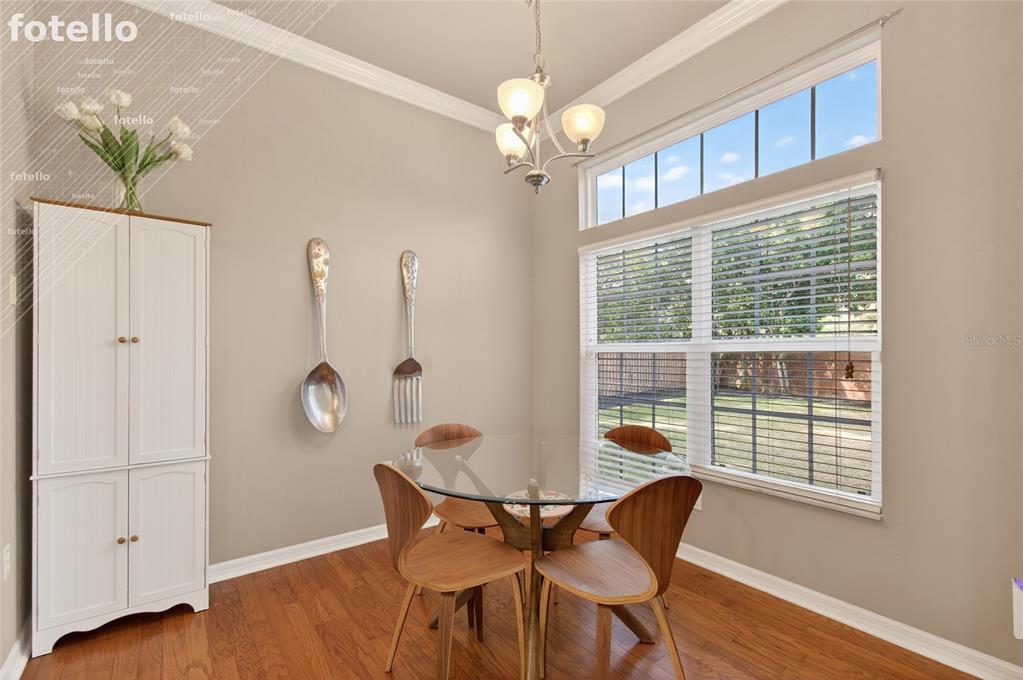 3762 Southwest 74th Drive Gainesville, FL 32608 - Photo 27 of 37 a view of a dining room with furniture wooden floor and chandelier