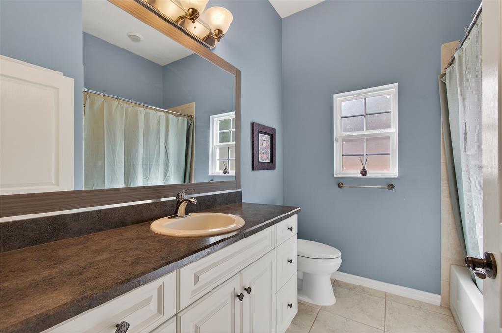 3762 Southwest 74th Drive Gainesville, FL 32608 - Photo 9 of 37 a bathroom with a sink a light fixture and a toilet