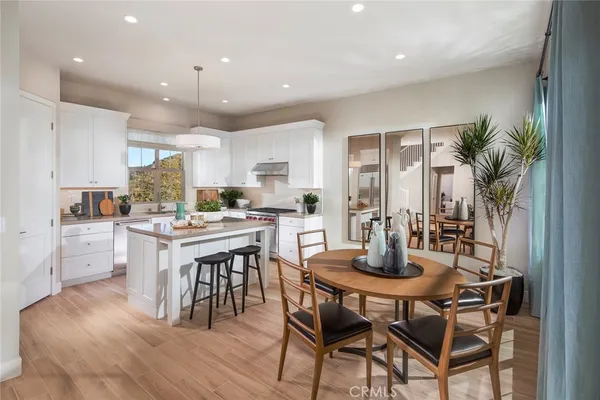 a kitchen with kitchen island granite countertop wooden floors and center island