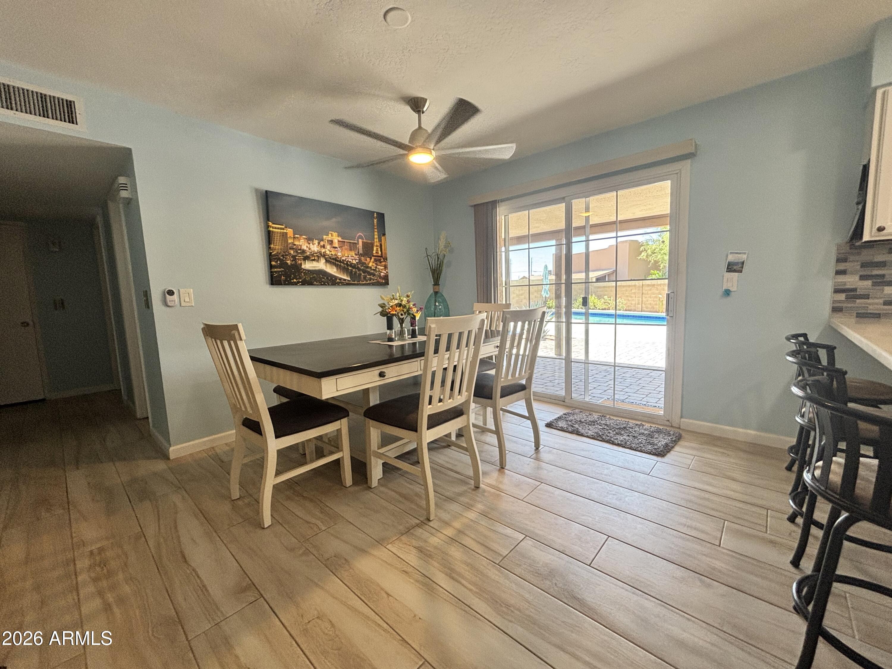 7745 East Mangun Road Mesa, AZ 85207 - Photo 20 of 35 a view of a dining room with furniture window and wooden floor