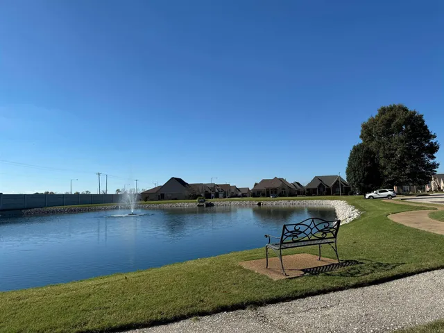 a view of a lake with lawn chairs