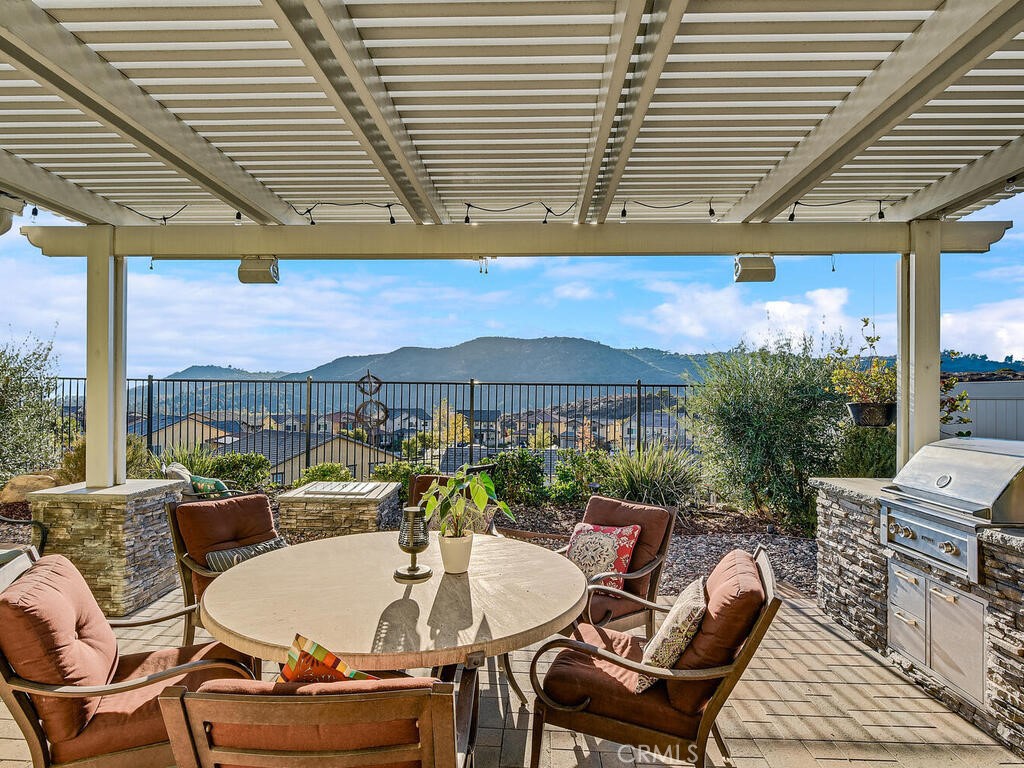 374 Ventasso Way Fallbrook, CA 92028 - Photo 16 of 42 a patio with a table and chairs and a barbeque