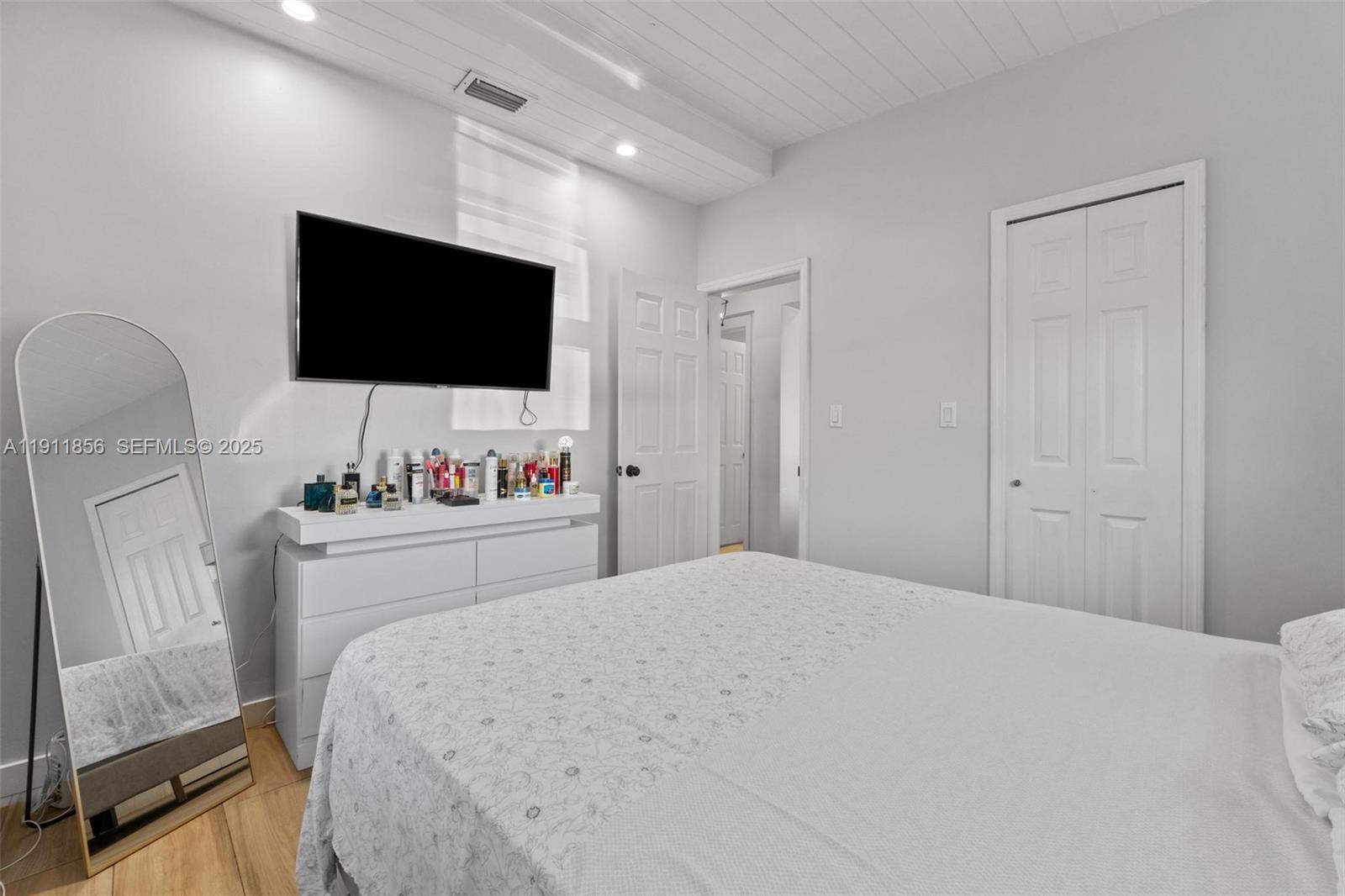 580 East 44th Street Hialeah, FL 33013 - Photo 11 of 41 a bedroom with a bed and a flat screen tv