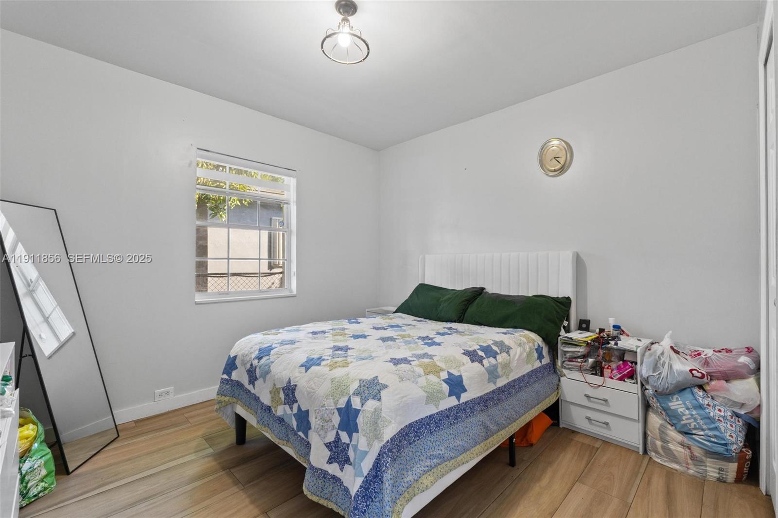 580 East 44th Street Hialeah, FL 33013 - Photo 13 of 41 a bedroom with a bed and wooden floor