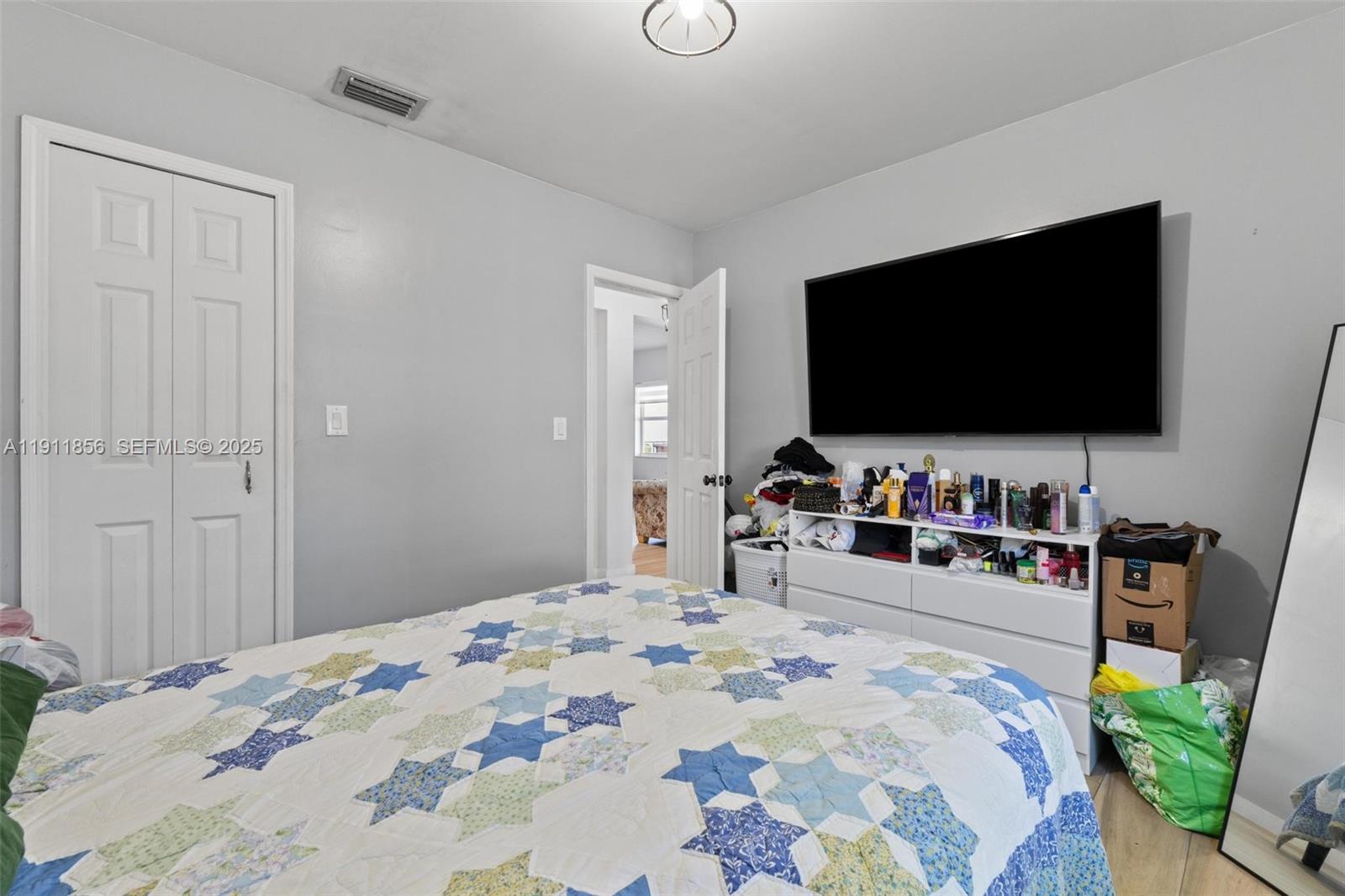 580 East 44th Street Hialeah, FL 33013 - Photo 14 of 41 a bedroom with a bed and a flat screen tv