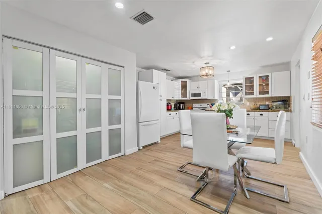 a kitchen with stainless steel appliances kitchen island granite countertop a refrigerator and cabinets