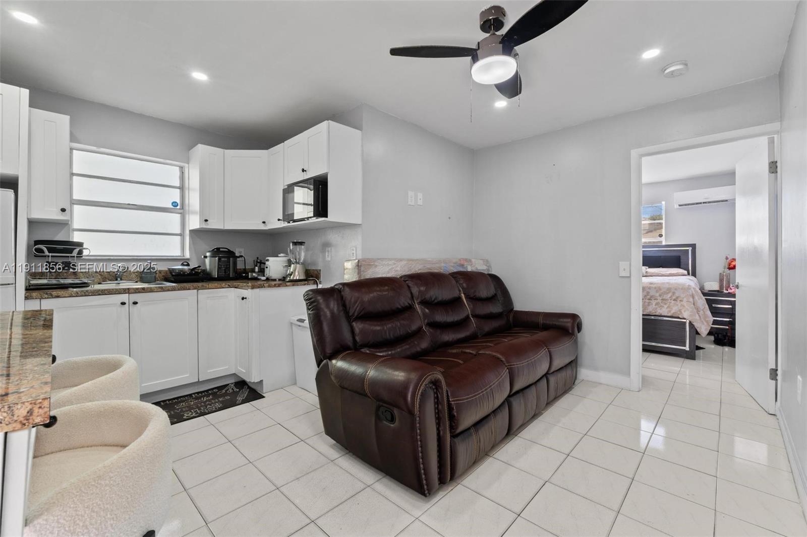 580 East 44th Street Hialeah, FL 33013 - Photo 23 of 41 a living room with furniture and kitchen view