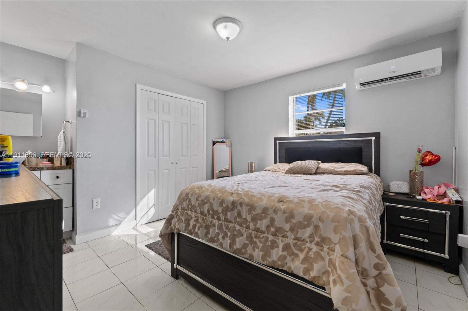580 East 44th Street Hialeah, FL 33013 - Photo 26 of 41 a bedroom with a bed and a tv on the dresser