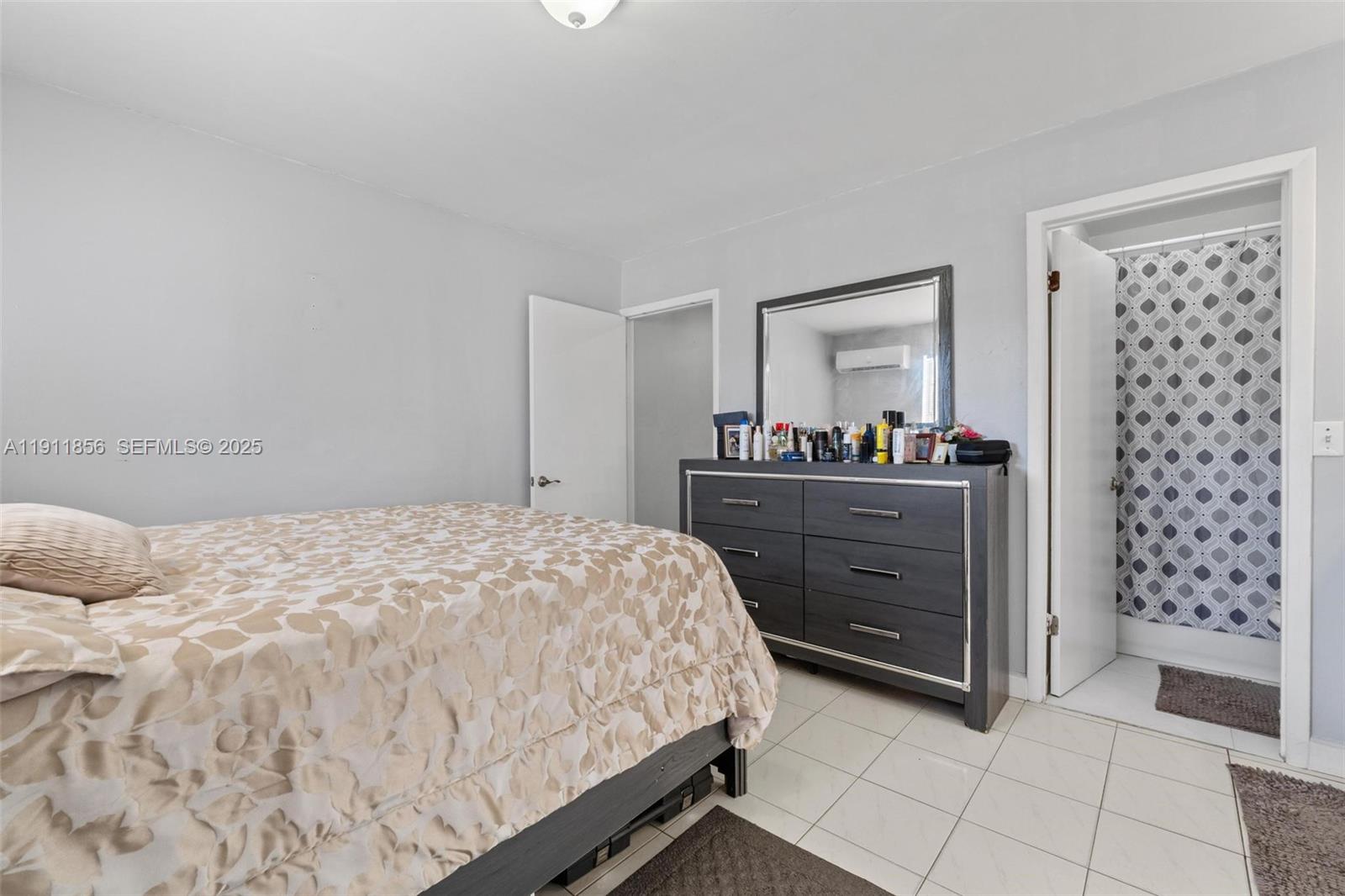 580 East 44th Street Hialeah, FL 33013 - Photo 27 of 41 a bedroom with a bed and a dresser