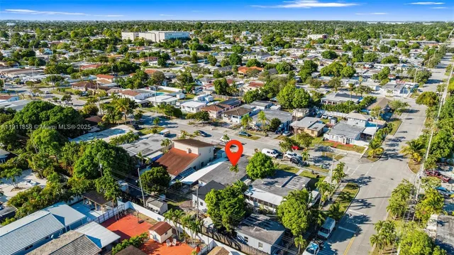 an aerial view of residential houses with outdoor space and street view