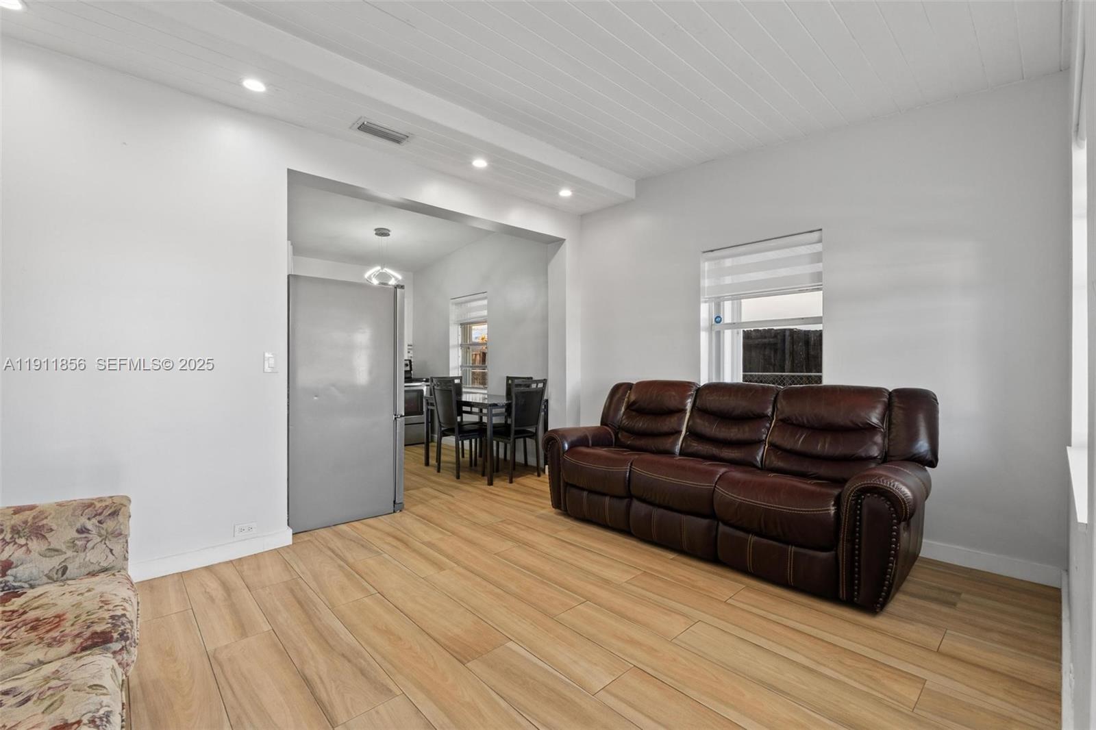 580 East 44th Street Hialeah, FL 33013 - Photo 4 of 41 a living room with furniture and a wooden floor