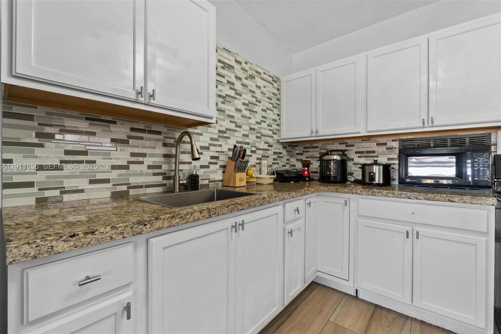 580 East 44th Street Hialeah, FL 33013 - Photo 8 of 41 a kitchen with stainless steel appliances granite countertop a sink a stove and cabinets