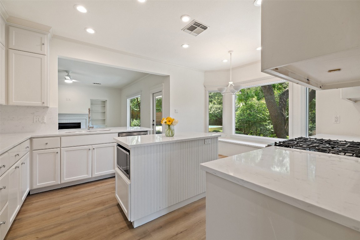 5700 Carry Back Lane Austin, TX 78746 - Photo 20 of 40 a kitchen with sink a stove and cabinets