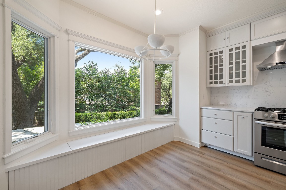 5700 Carry Back Lane Austin, TX 78746 - Photo 21 of 40 a view of a kitchen with wooden floor electric appliances and windows