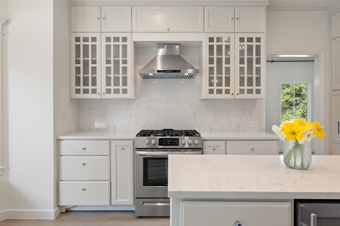 5700 Carry Back Lane Austin, TX 78746 - Photo 22 of 40 a kitchen with cabinets and appliances