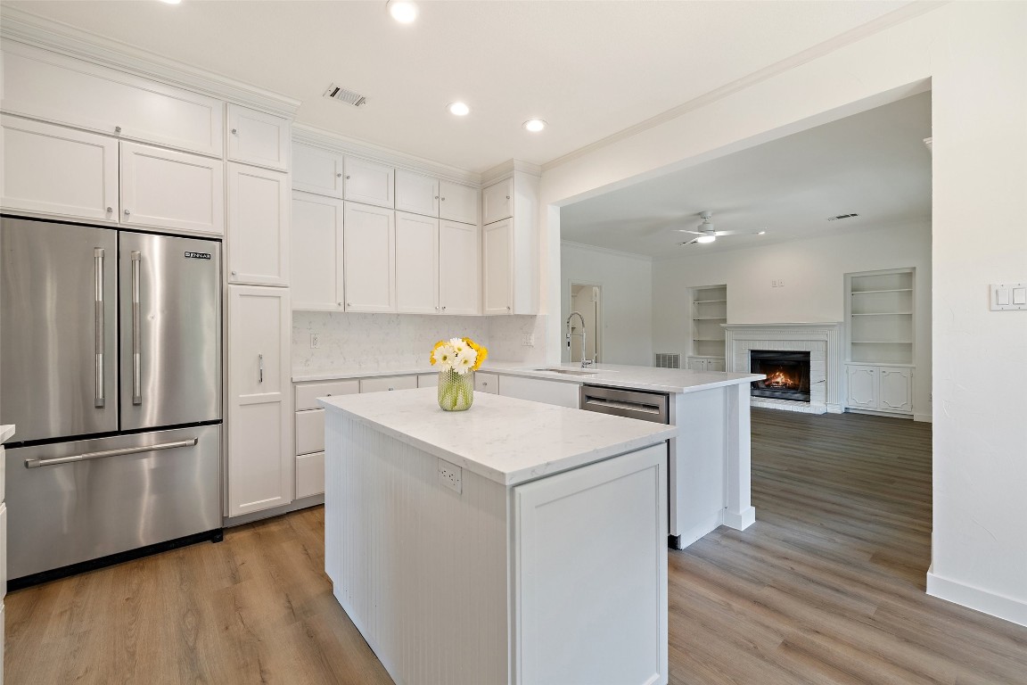 5700 Carry Back Lane Austin, TX 78746 - Photo 23 of 40 a kitchen with a sink appliances and wooden floor