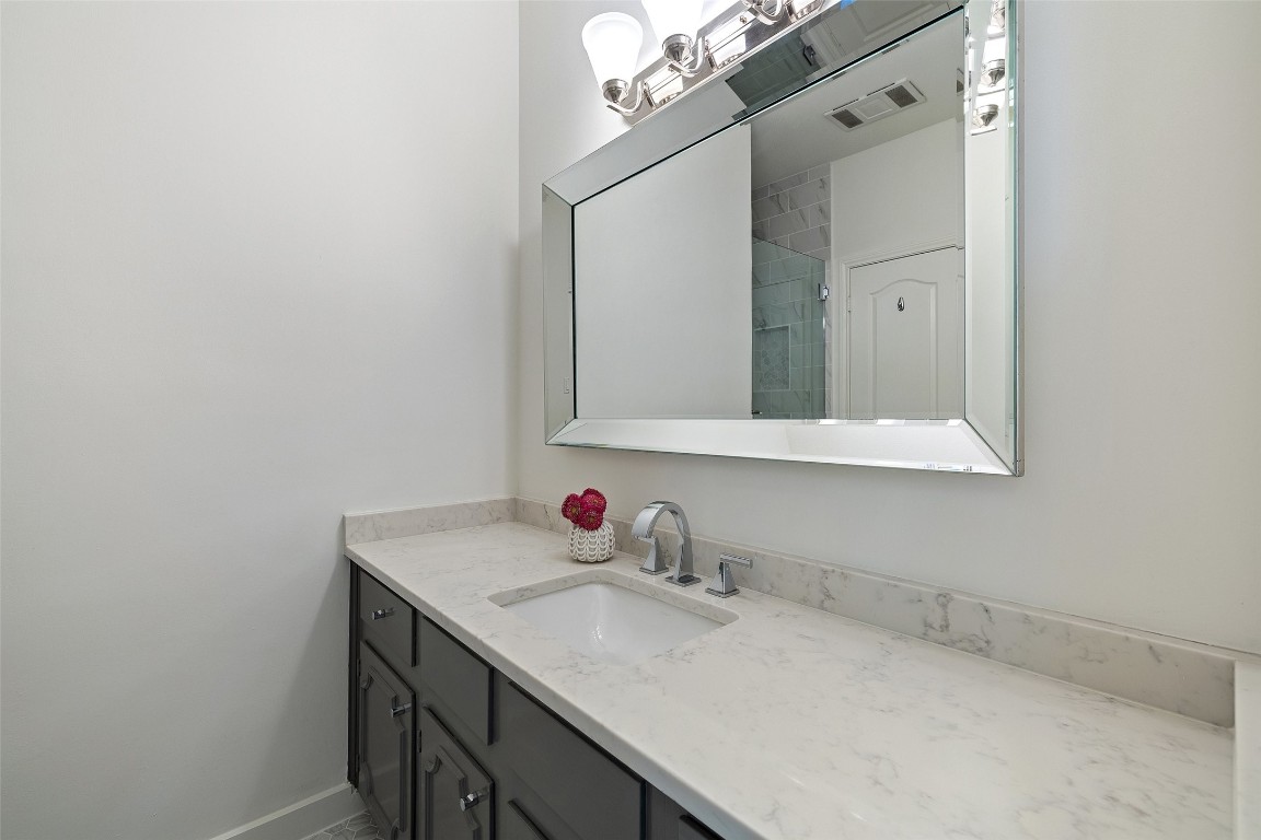 5700 Carry Back Lane Austin, TX 78746 - Photo 26 of 40 a bathroom with a sink vanity and mirror