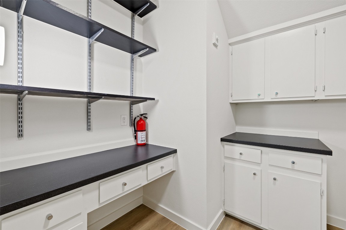 5700 Carry Back Lane Austin, TX 78746 - Photo 28 of 40 a kitchen with white cabinets and sink
