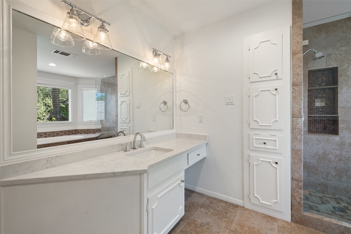 5700 Carry Back Lane Austin, TX 78746 - Photo 31 of 40 a bathroom with a sink vanity and a mirror