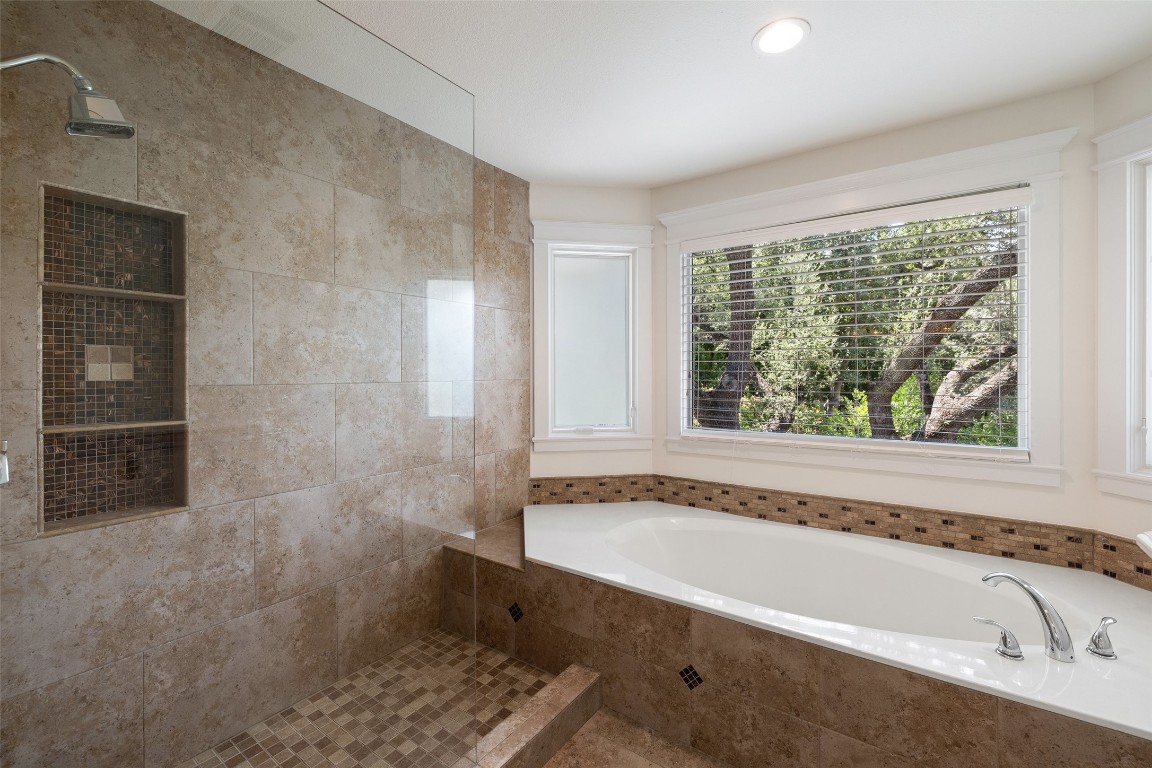 5700 Carry Back Lane Austin, TX 78746 - Photo 33 of 40 a bathroom with a bathtub and a shower