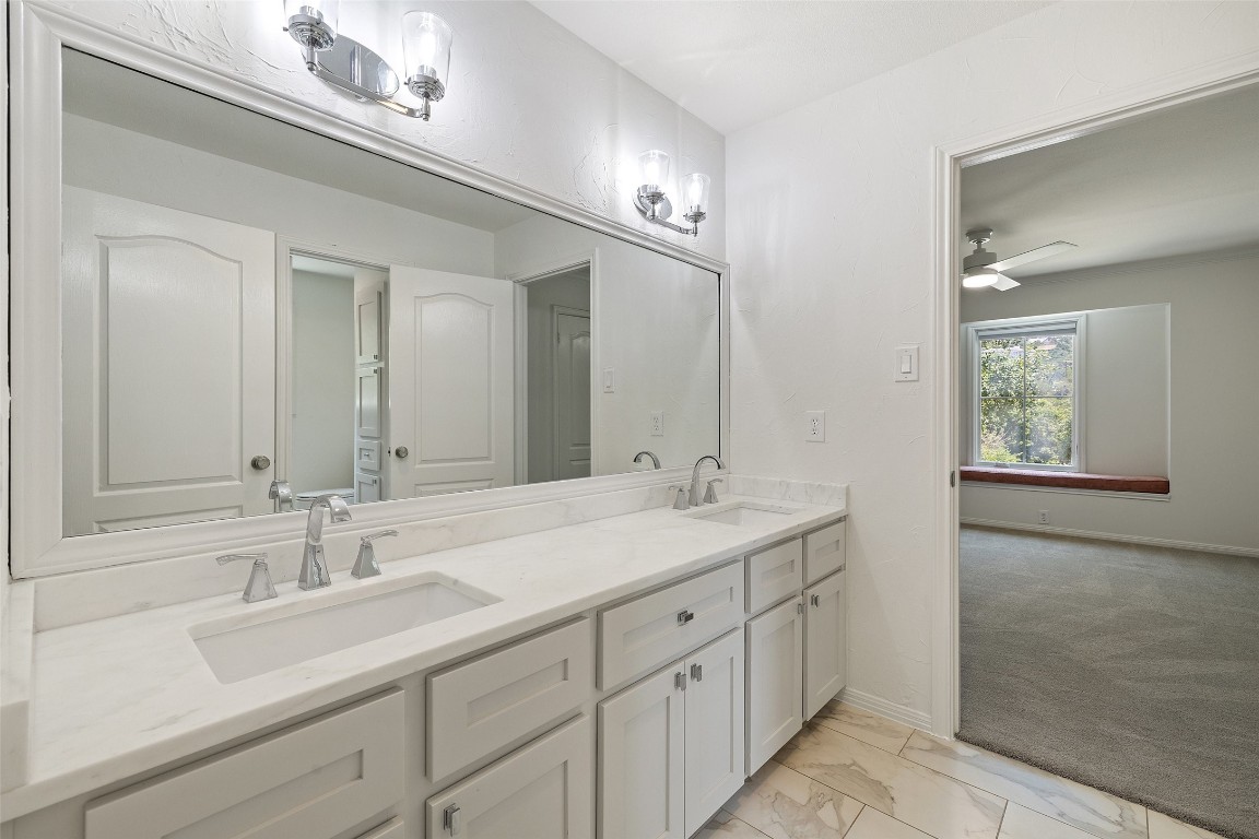 5700 Carry Back Lane Austin, TX 78746 - Photo 35 of 40 a bathroom with a sink double vanity and a mirror