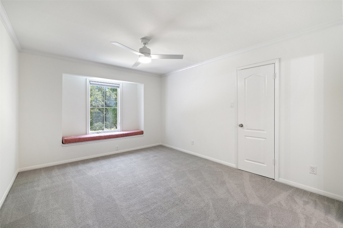 5700 Carry Back Lane Austin, TX 78746 - Photo 37 of 40 an empty room with windows and fan