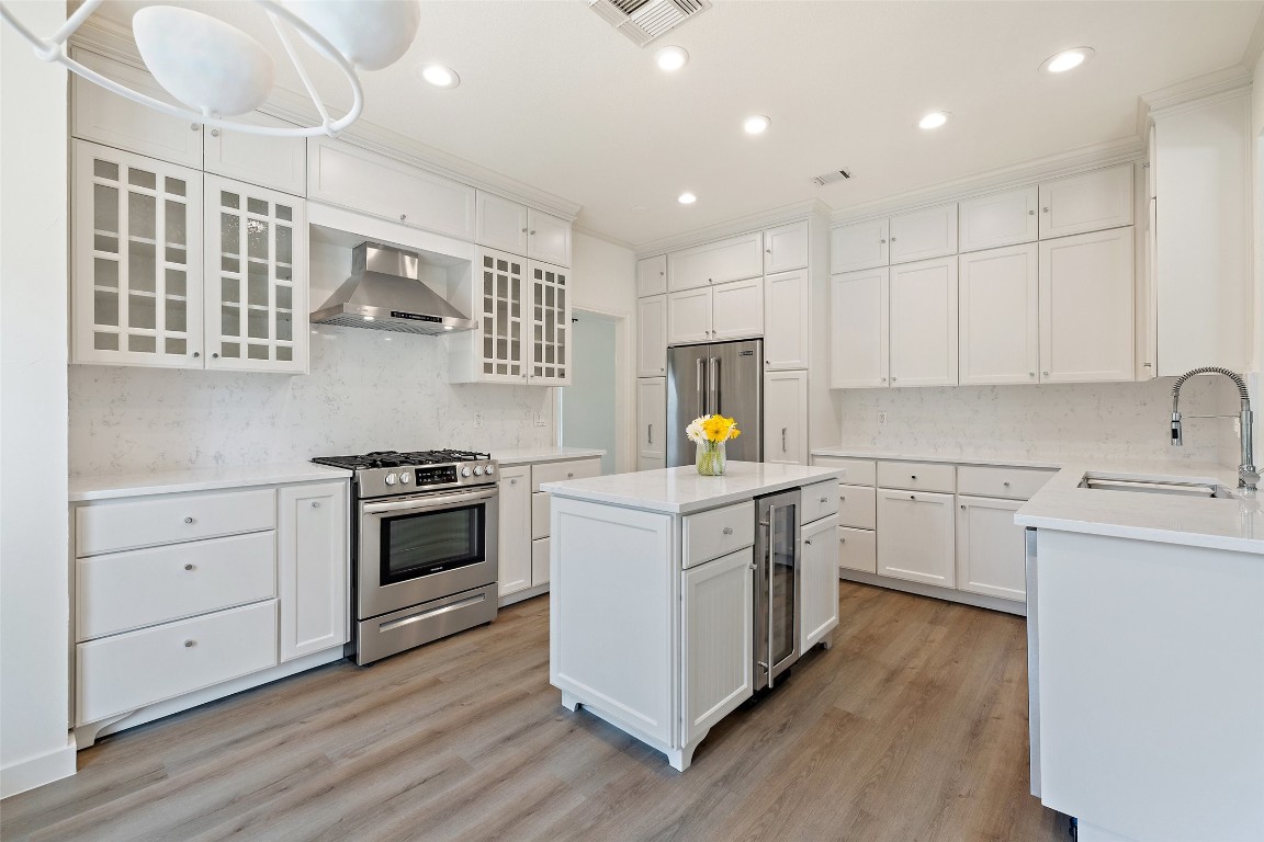 5700 Carry Back Lane Austin, TX 78746 - Photo 5 of 40 a kitchen with a sink a stove and cabinets