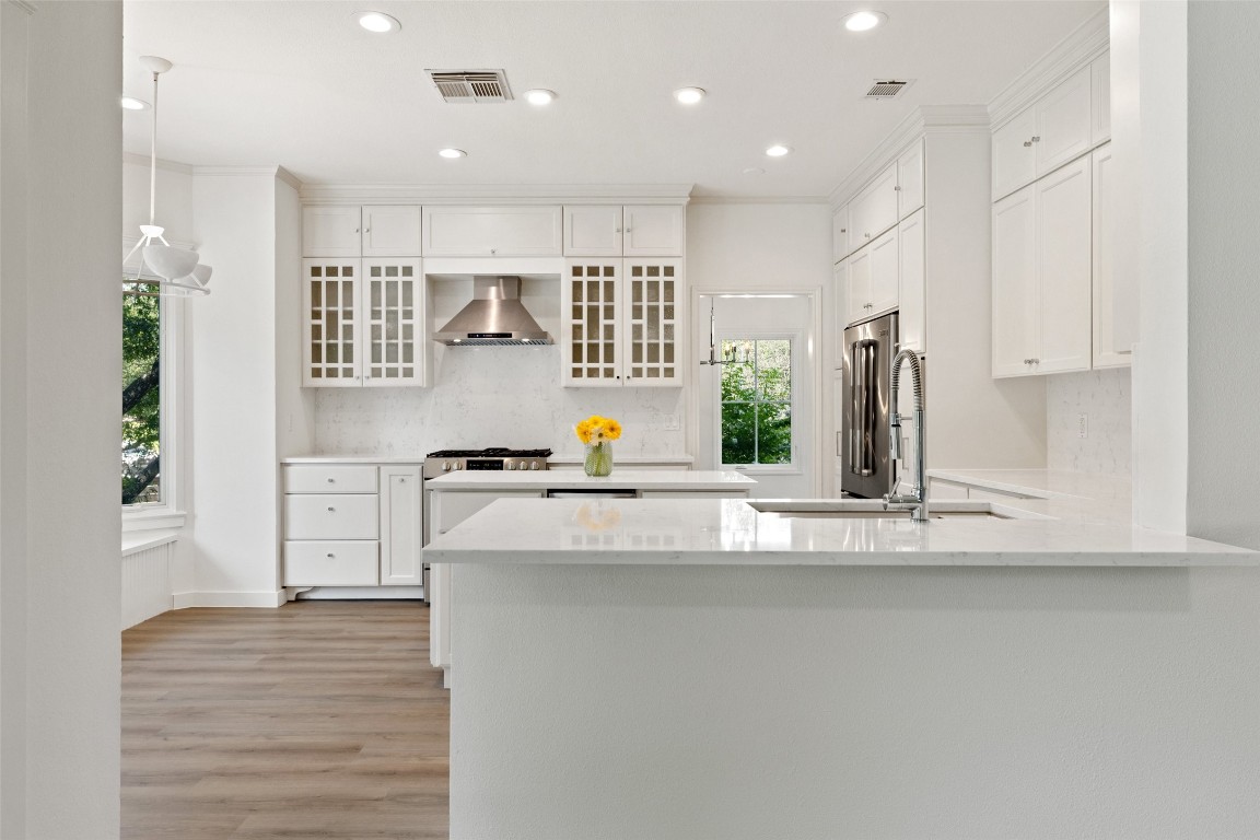 5700 Carry Back Lane Austin, TX 78746 - Photo 6 of 40 a kitchen with stainless steel appliances granite countertop a sink and a refrigerator