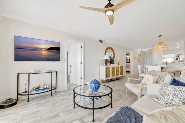 a living room with furniture a rug and a flat screen tv